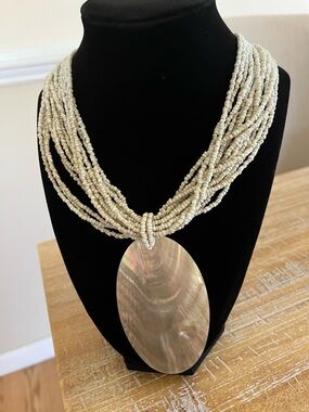 Beige Multi-Strand Beaded Necklace with Iridescent Shell Pendant